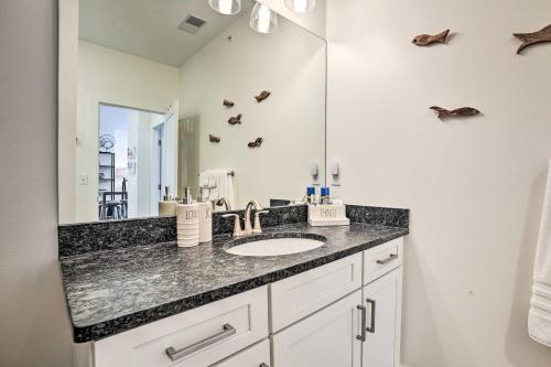 a bathroom with a sink and a mirror at Traverse City Condo - Half-Mile to Front Street in Traverse City