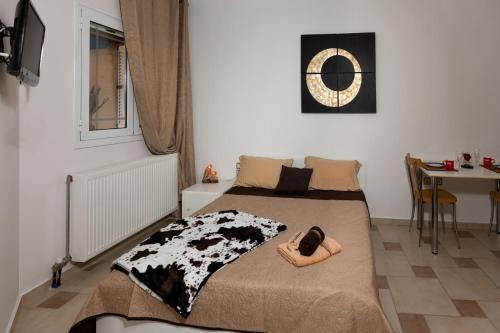 a bedroom with a bed with a pair of shoes on it at Martha's studios Kefalonia in Kefallonia