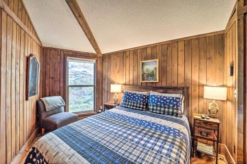 a bedroom with a bed and a chair and a window at 1/2 Mi to Skiing! Beech Mountain Cabin w/ Deck in Beech Mountain