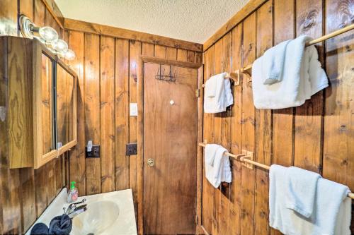 a bathroom with wooden walls and a sink and towels at 1/2 Mi to Skiing! Beech Mountain Cabin w/ Deck in Beech Mountain