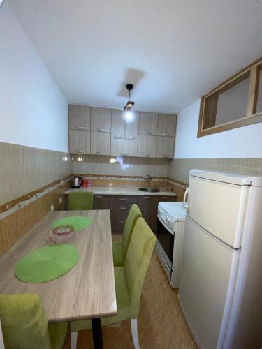 a kitchen with a table and chairs and a refrigerator at Skadar Lake Apartment -Anja in Vranjina