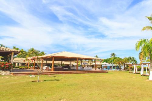 a pavilion at a resort with palm trees at Porto Seguro Eco Bahia Hotel in Porto Seguro