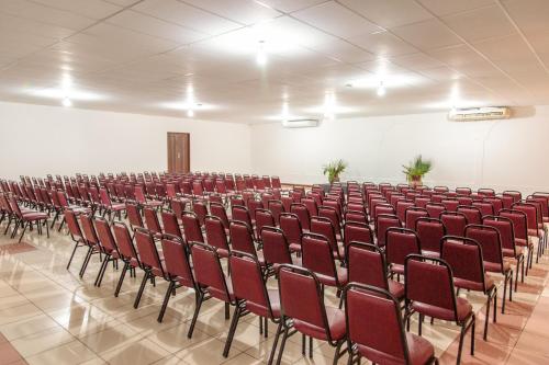 an empty hall with red chairs in a room at Porto Seguro Eco Bahia Hotel in Porto Seguro