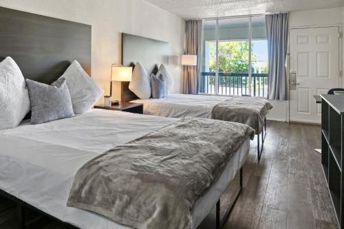 a hotel room with two beds and a window at Stayable St Augustine in St. Augustine