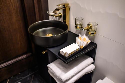 a bathroom with a sink and towels on a table at Diamond svečių namai in Kaunas