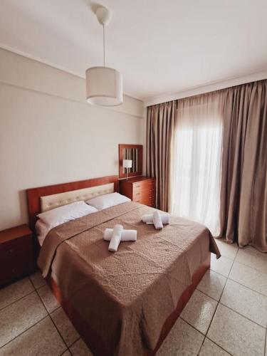 a bedroom with a bed with two towels on it at Viktoria Sea View Apartment in Perea
