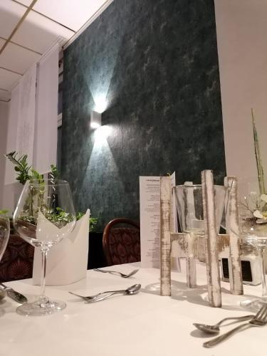 a table with glasses and silverware on top of it at Heidehotel Lubast in Lubast