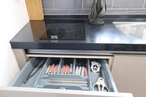 a drawer in a kitchen with alot of tools at HAH Guesthouse in Seoul