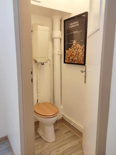 a bathroom with a toilet and a picture on the wall at Groom Épernay - Le Petit Tonnelier in Épernay