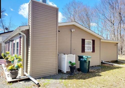 a house with a garbage can in front of it at The Family Getaway in Tobyhanna