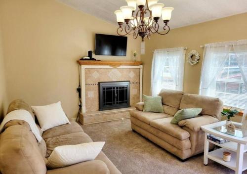 a living room with two couches and a fireplace at The Family Getaway in Tobyhanna