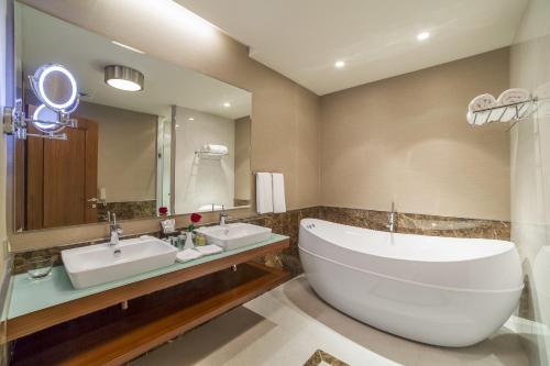 a bathroom with two sinks and a large mirror at Borjomi Likani Health & Spa Centre in Borjomi