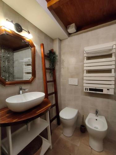 a bathroom with a sink and a toilet and a mirror at Dal Podestà in San Gemini