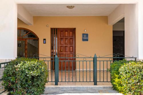 a front door of a building with a gate at 4keys House Superior in Tripolis