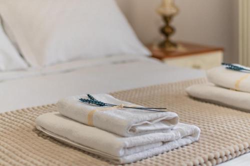 three towels sitting on top of a bed at 4keys House Superior in Tripolis