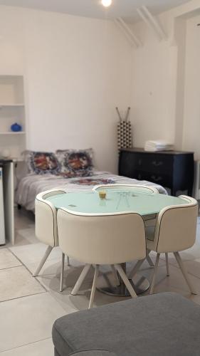 une pièce avec une table et deux chaises et un lit dans l'établissement Studio @Paris-Centre Montmarte Sacre-coeur Opera Louvre, à Paris