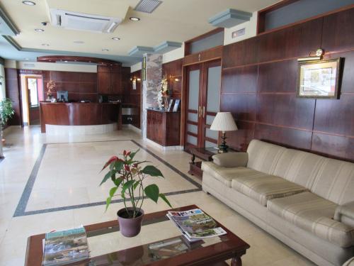a living room with a couch and a table at Hotel Virgen del Camino Pontevedra in Pontevedra