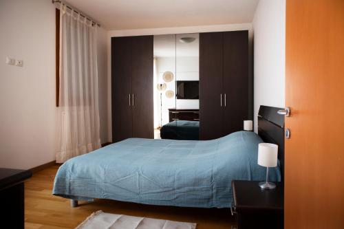 a bedroom with a bed with a blue bedspread at Laguna Venice Apartment in Dogaletto