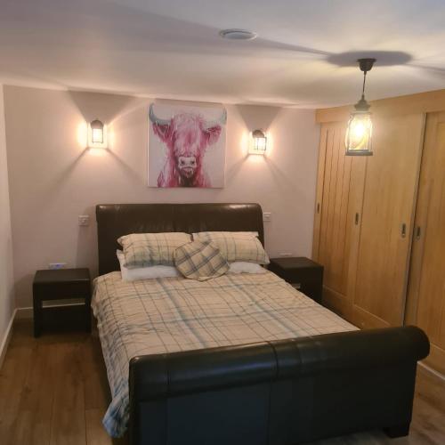 a bedroom with a bed with two night stands at The Coach House in Blackpool