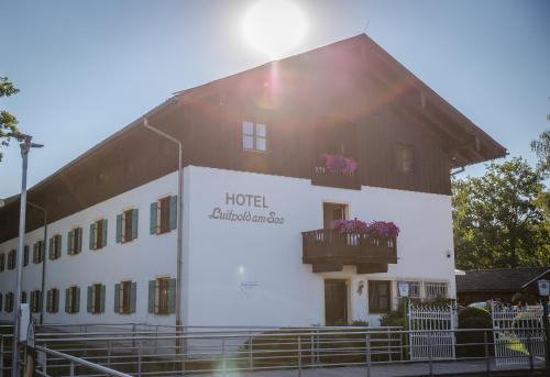 a hotel with a balcony on a building at Hotel Luitpold am See in Prien am Chiemsee