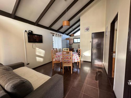 a living room with a table and a dining room at Cabañas Florencia La Serena in La Serena