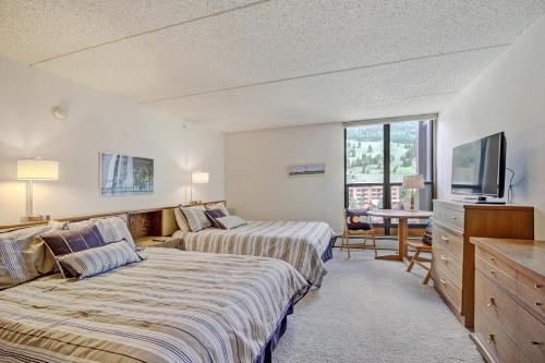 a hotel room with two beds and a television at MP522 Mountain Plaza Hotel Room in Copper Mountain