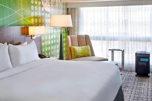 a hotel room with a bed and a chair at Renaissance Nashville Hotel in Nashville