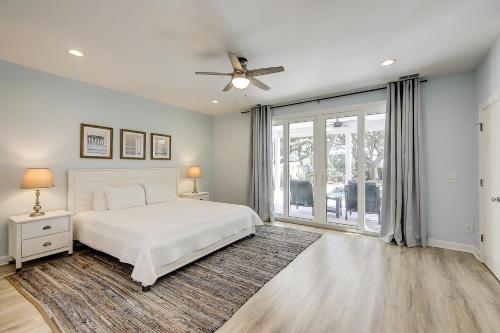 a bedroom with a white bed and a ceiling fan at Carolina Boulevard 808 in Isle of Palms
