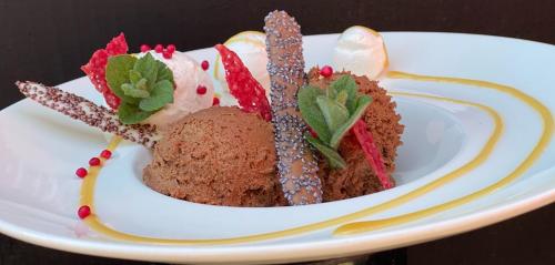 a white plate with a piece of cake on it at Herberg de Kemper in Markelo