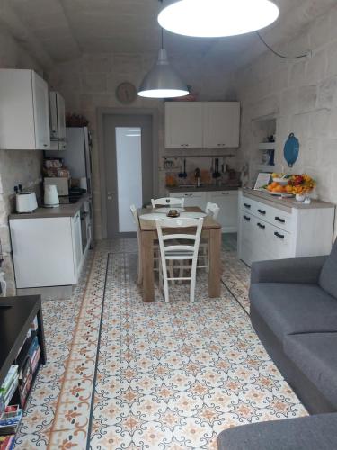 a living room with a table and a kitchen at One bedroom apartment in Qormi