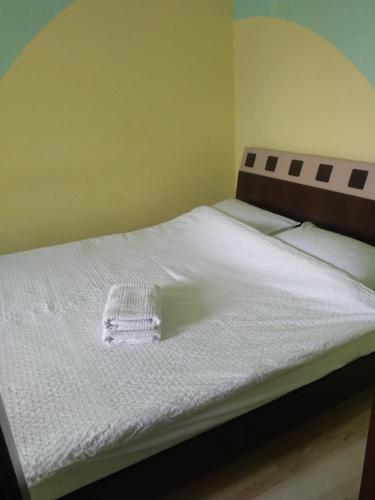 a white bed with a basket on top of it at Apartment on Kravchuka 11b in Lutsk
