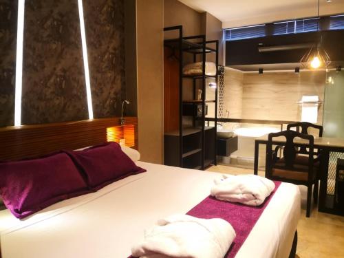 een slaapkamer met een bed met handdoeken erop bij Hotel Las Lomas in Lima