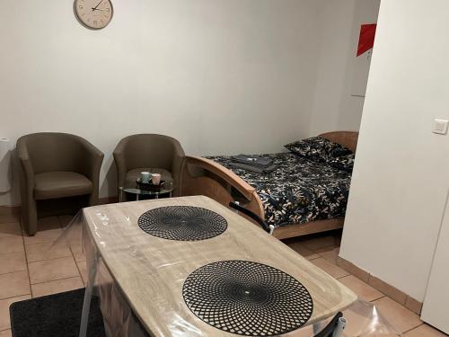 a room with a bed and a table with a fan at Chez doudou in Roanne