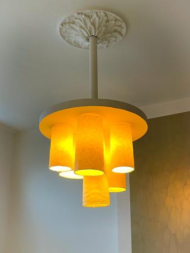 a chandelier hanging from a ceiling at La Porte Rouge - The Red Door in Oudenaarde