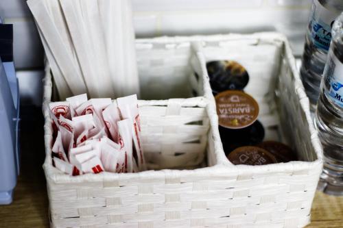 a basket with a bottle of water and some drinks at Modern & Comfortable Apartament Cismigiu Park - POP3 in Bucharest