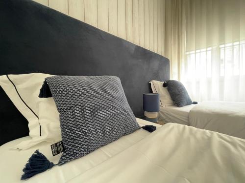 a bedroom with two beds and a wall at PORTA NOVA Historic Center - Apartments Collection by Perpetual Relax in Braga