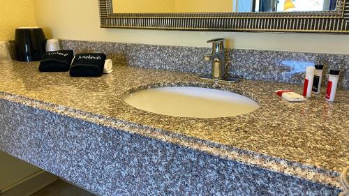 a bathroom counter with a sink in a bathroom at Lake Logan Inn in Logan
