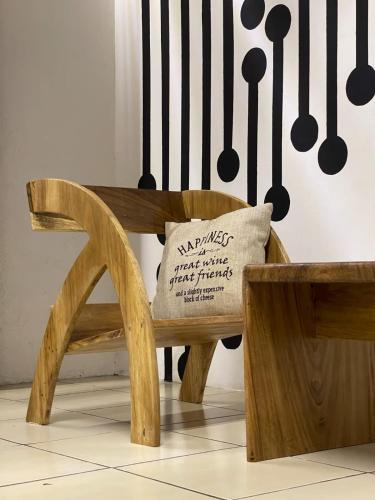 a wooden bench with a pillow on it at The Wabi Sabi in León
