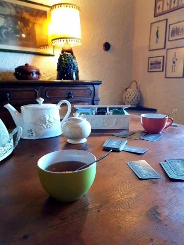 a wooden table with a bowl of tea on it at La Baronessa Country House in Montefiascone