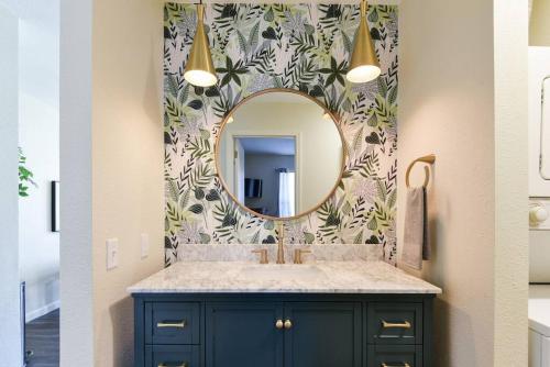 a bathroom with a sink and a mirror at Sparkling Designer 3 bed Suite by Taneycomo in Branson