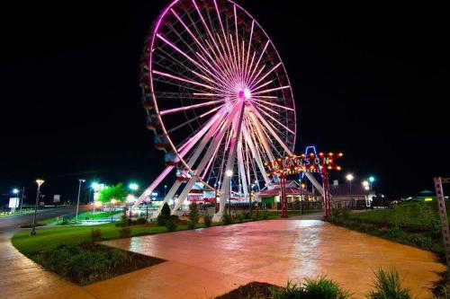 a large ferris wheel in a park at night at Sparkling Designer 3 bed Suite by Taneycomo in Branson
