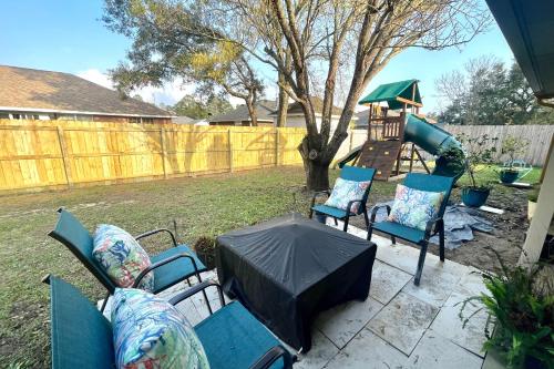 a patio with chairs and an umbrella and a playground at Pretty in Perdido Key in Perdido Key