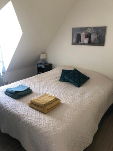 a bedroom with a bed with two towels on it at le Nid perché in Brou