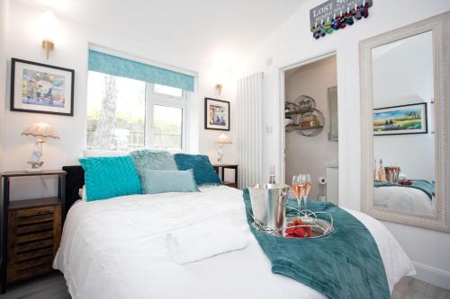 a bedroom with a bed with a bowl of fruit on it at The Bearded Goat Den - A rural retreat at this modern holiday cottage in Saint Leonards
