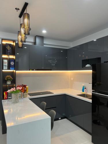 a kitchen with black cabinets and a white counter top at Noric homestay in Hue