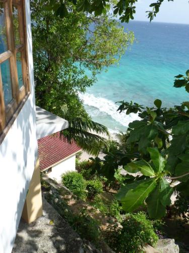 a view of the ocean from a window at Patatran Village Hotel in La Digue