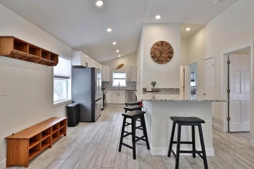 a kitchen with two bar stools and a counter top at Rutland's Hidden Gem- 2 BR 1BA Renovated Home Close to Everything home in Rutland