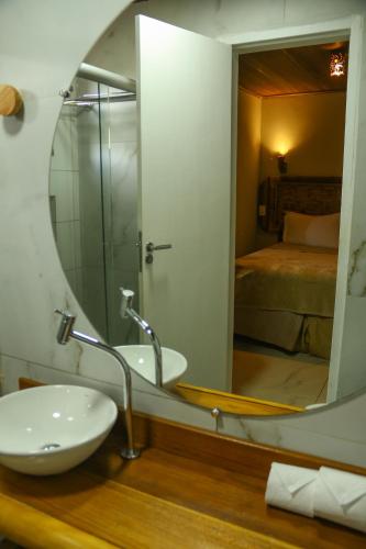 a bathroom with a sink and a mirror at Casa do Imperador in Fernando de Noronha