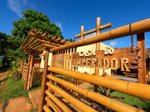 a wooden fence with a sign in front of a building at Casa do Imperador in Fernando de Noronha