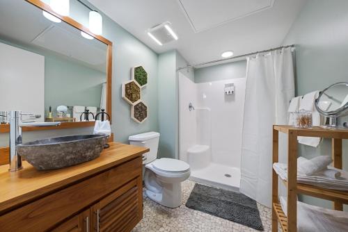 a bathroom with a sink and a toilet and a shower at Industrial Loft Apartments in the Beautiful Superior Building Minutes from FirstEnergy Stadium 220 in Cleveland